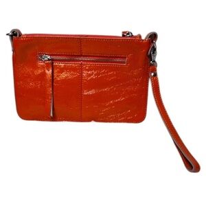 DISSONA Italy - orange patent leather wristlet.